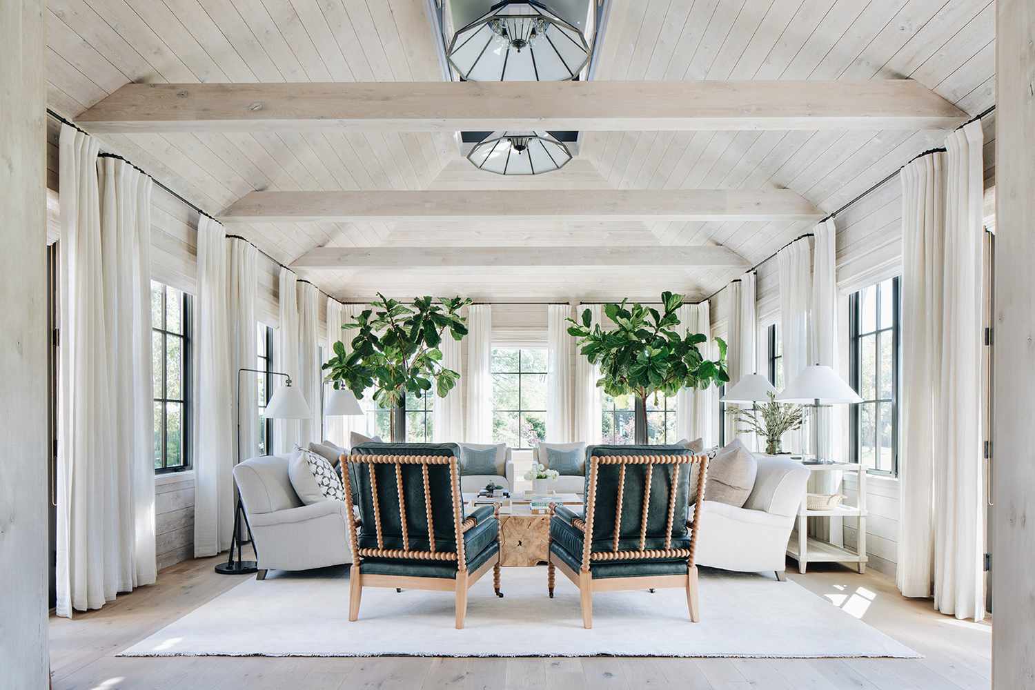 Living Room with many windows and curtains with wood walls and ceiling