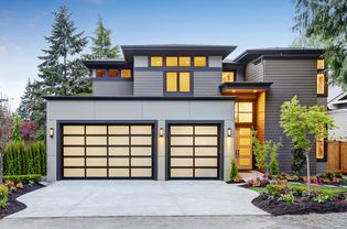 Luxury modern home with a glass garage door