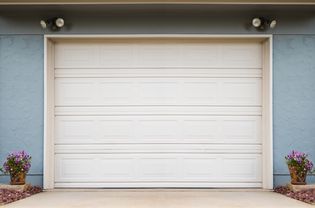 Blue house with white garage door