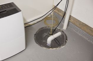 Basement sump pump in concrete floor