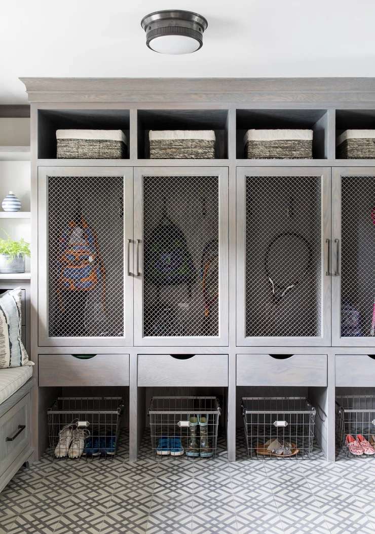 An organized mud room with lockers.