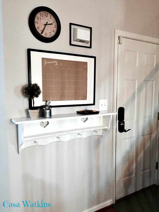 An entryway with a key rack and calendar.