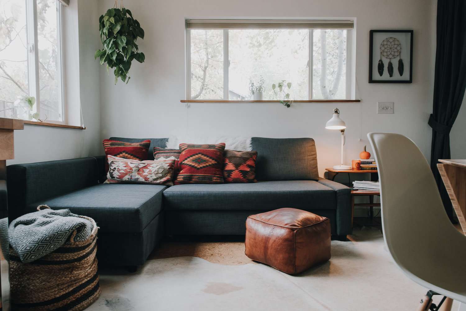 A gray sectional couch in a white room.