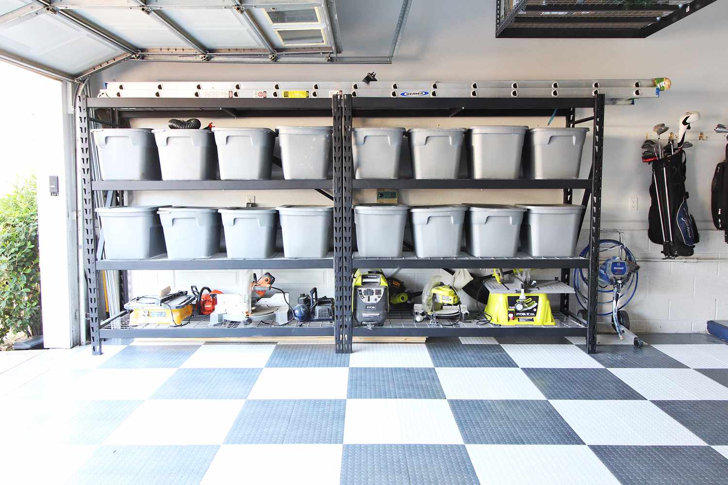 Tubs organized in a garage.