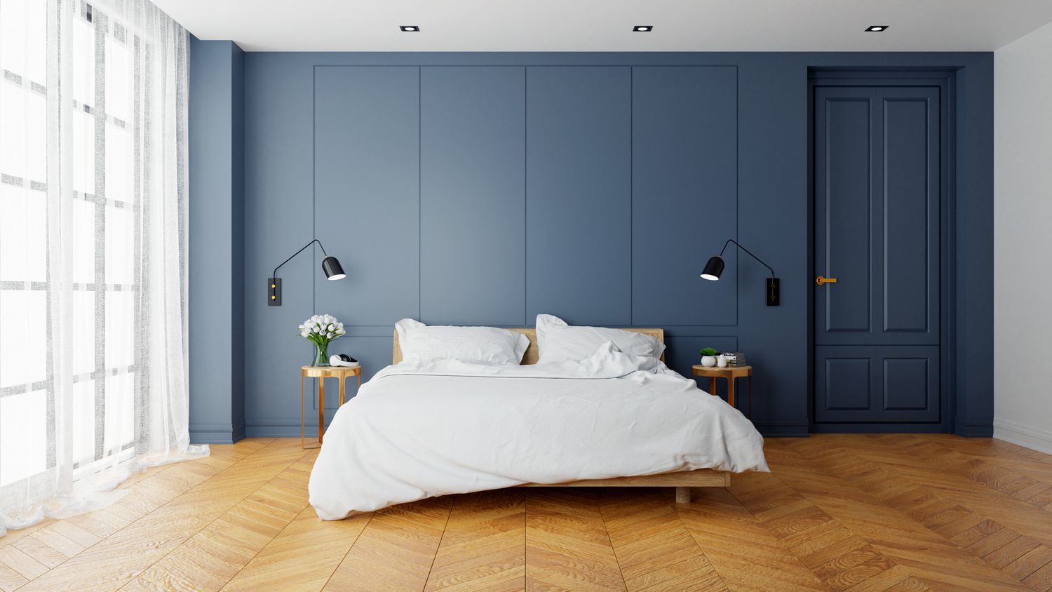 A soothing blue bedroom with a white bed.