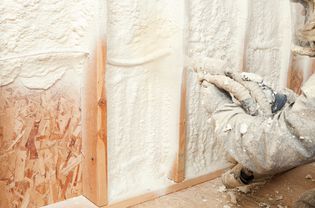 Person installing spray foam insulation